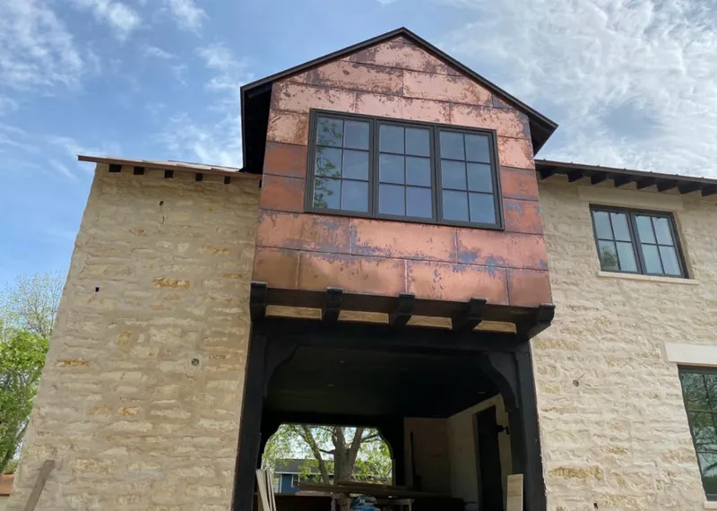 Copper metal panel facade on a stone building for Roof Repair in New Smyrna Beach
