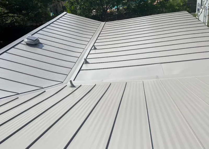Solar attic fan installed on a metal roof for Roof Ventilation in New Smyrna Beach